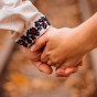 closeup-couple-s-hands-held-together-rails.jpg